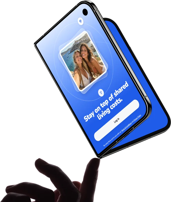 Hand holding a foldable phone showing a shared living costs app login screen