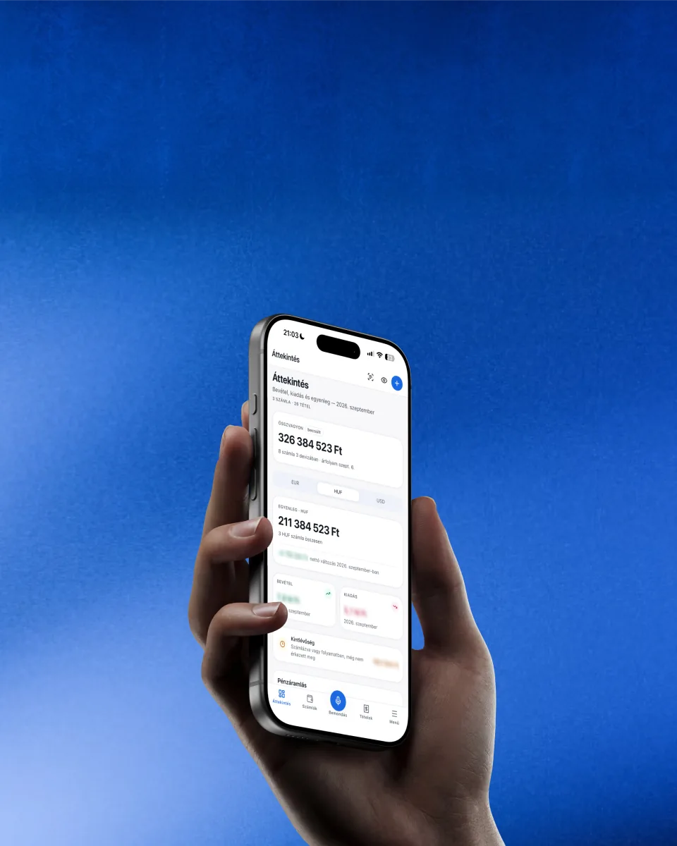 Hand holding a phone with a finance app overview showing account balances in forint